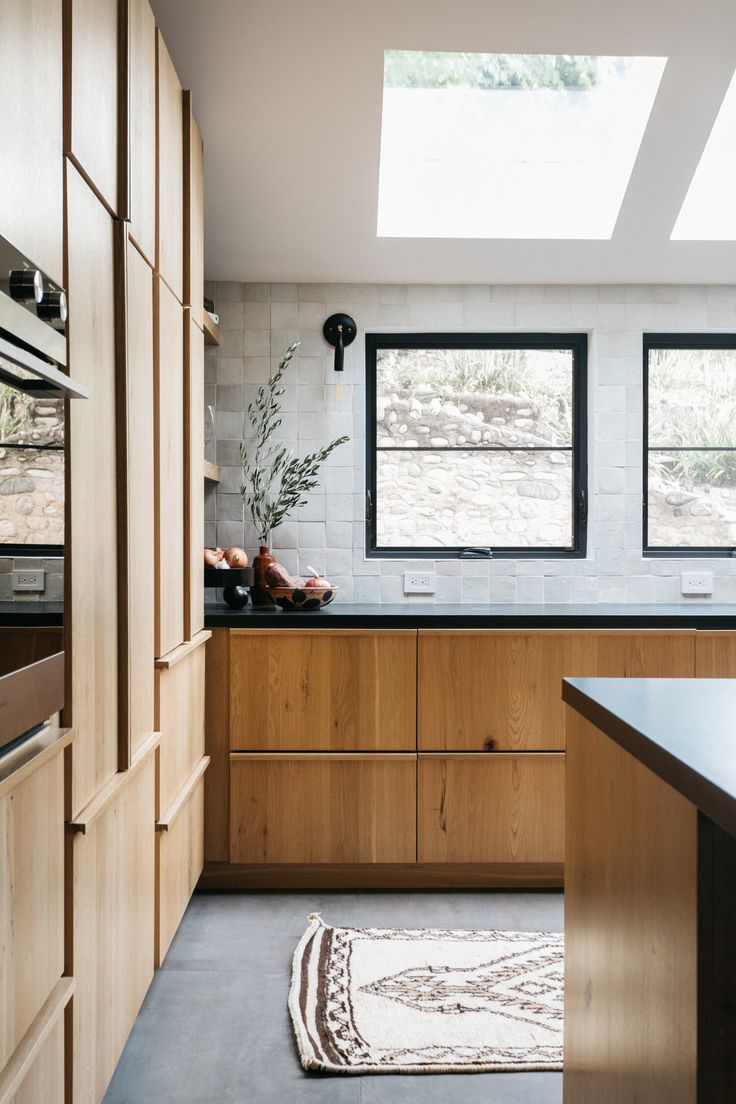 the kitchen is clean and ready for us to use it's natural wood cabinetry