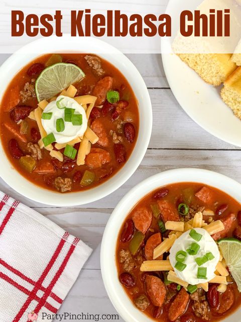 two bowls of chili with sour cream and tortilla chips on the side next to each other