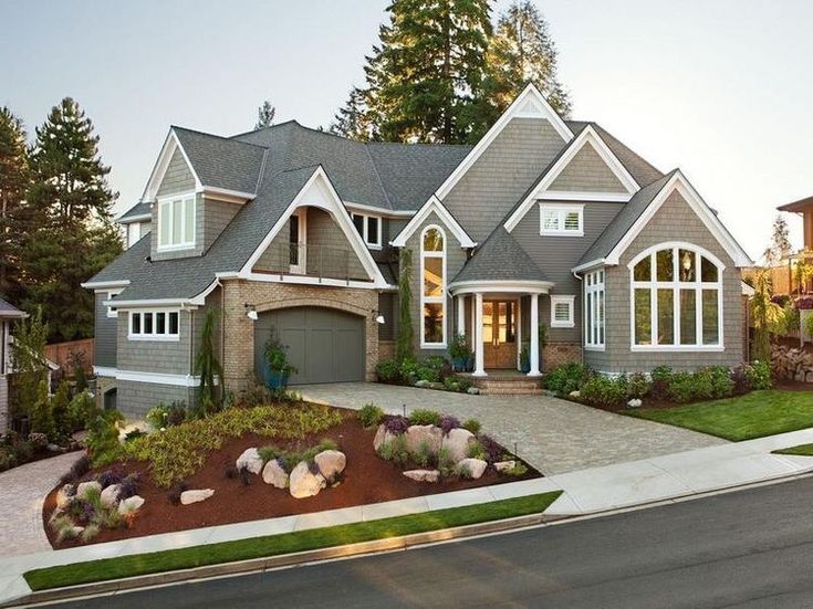 a large house with lots of windows and landscaping