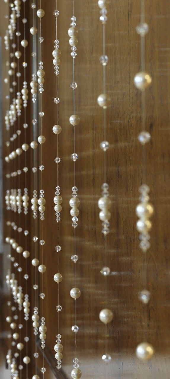 pearls hanging from the side of a wooden wall