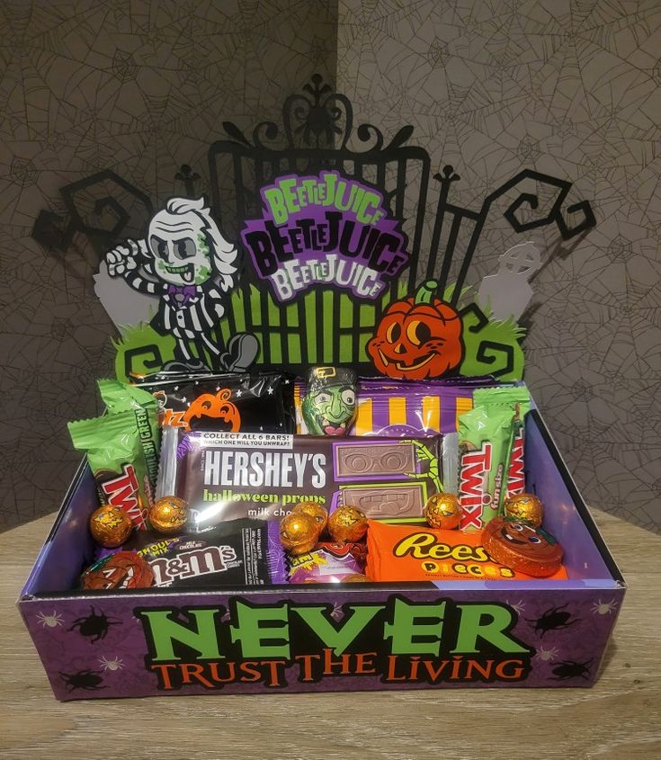 a purple box filled with candy and candies sitting on top of a wooden table