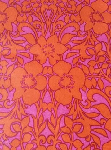 an orange and pink background with flowers on it