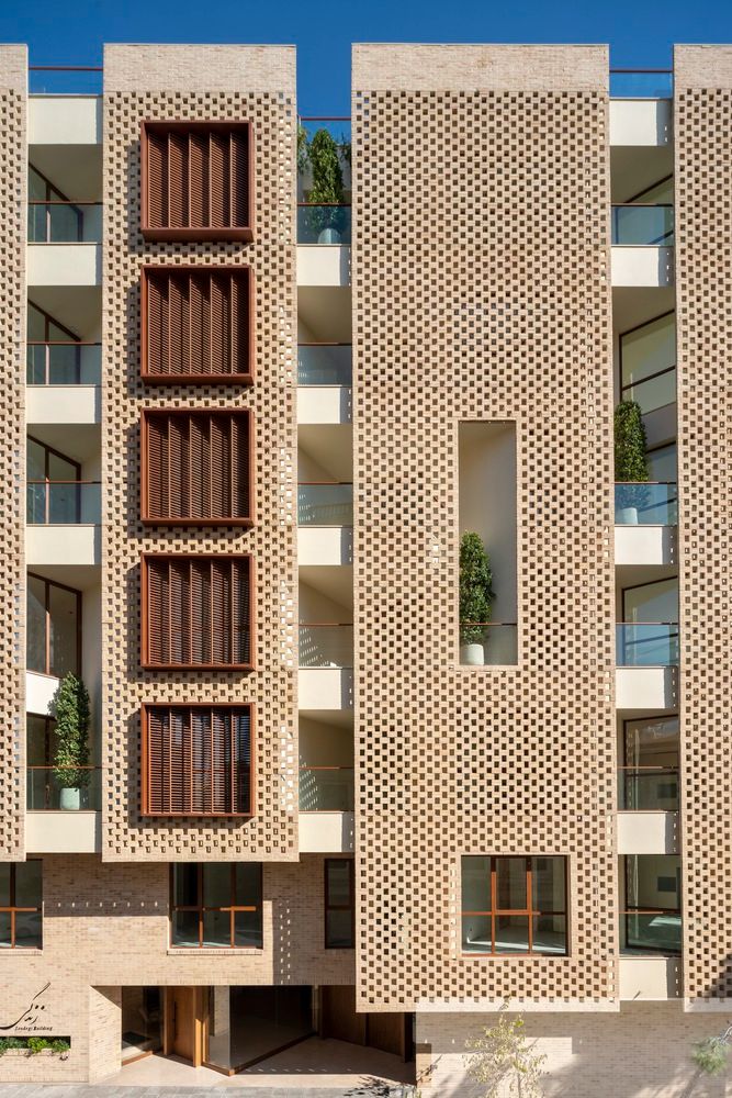 an apartment building with brick facade and balconies