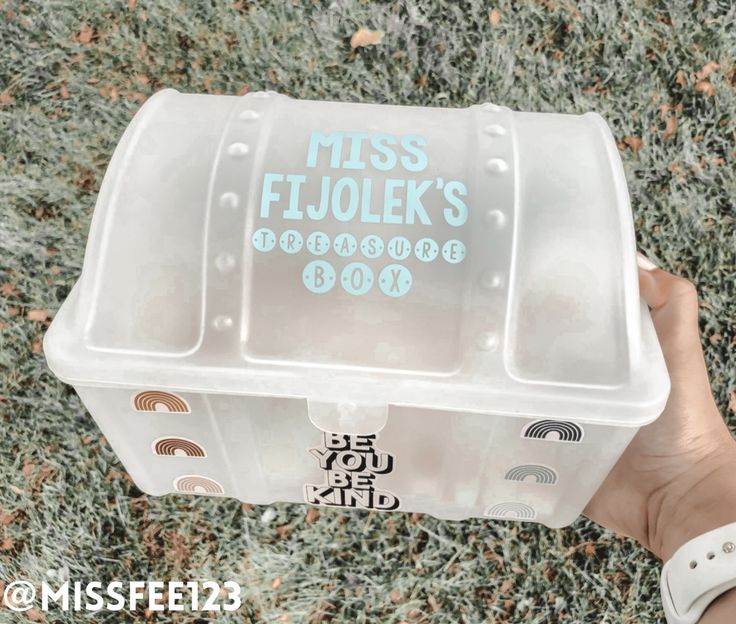 a person holding a plastic container with the words miss fluolek's on it