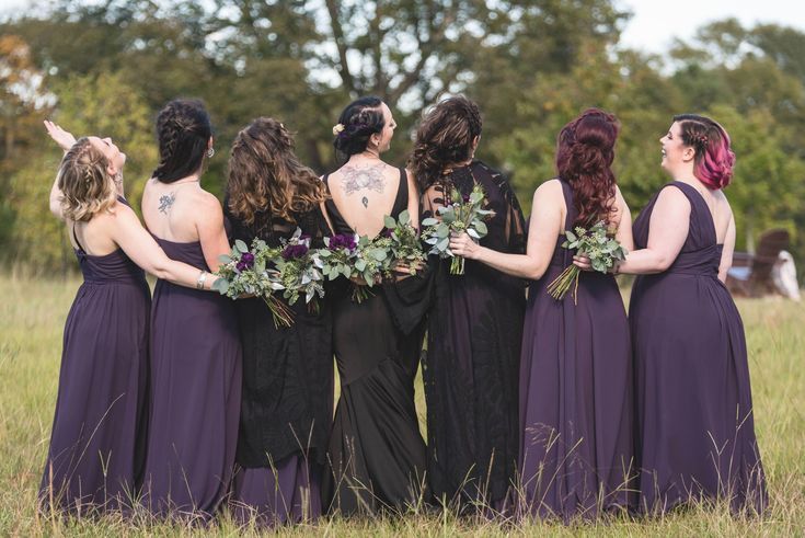 a group of women standing next to each other in a field