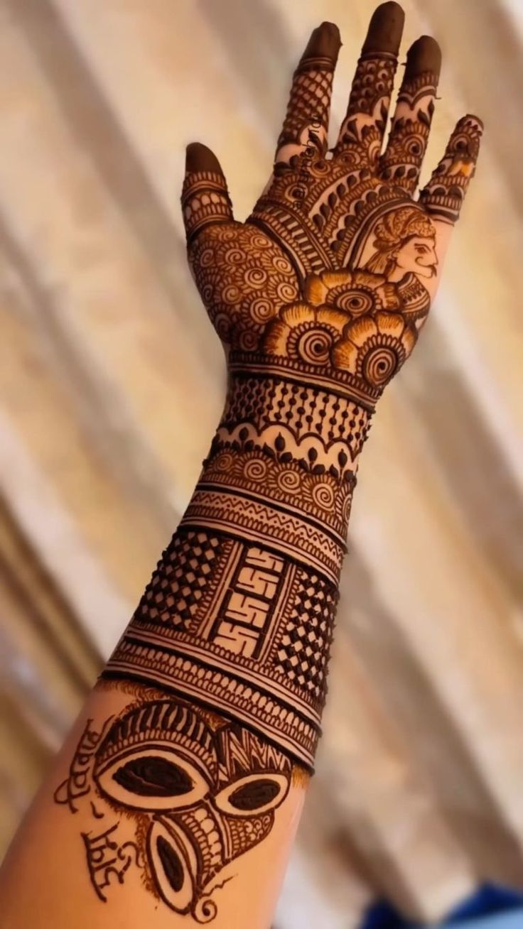 a woman's hand is decorated with hennap and intricate designs on it