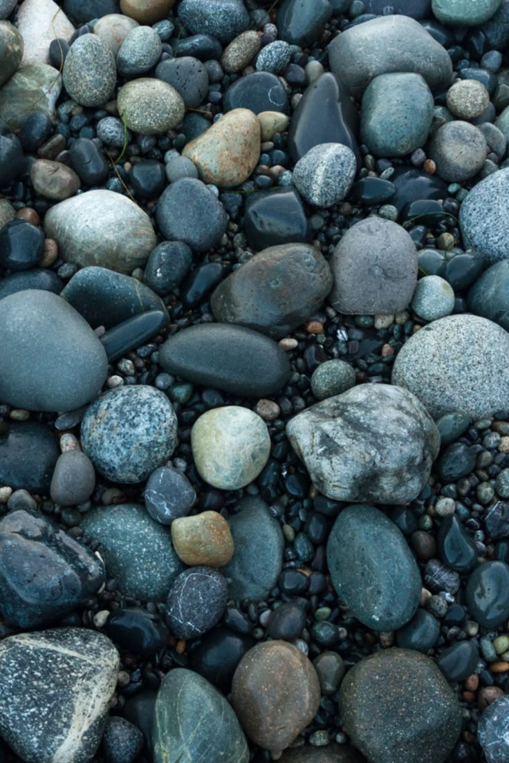 rocks and gravel are arranged together on the ground