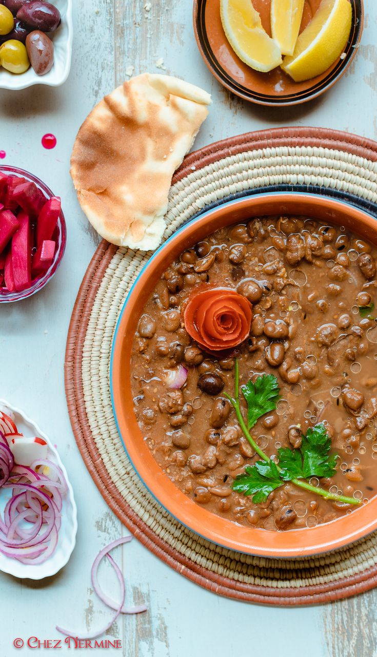 a bowl filled with beans and vegetables next to other foods