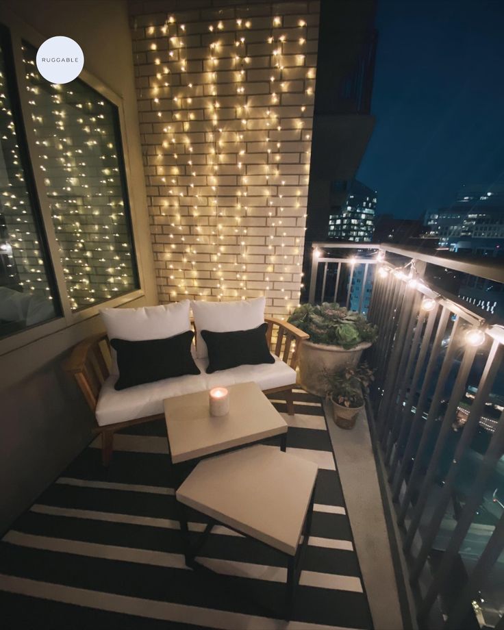 the balcony is decorated with lights and furniture