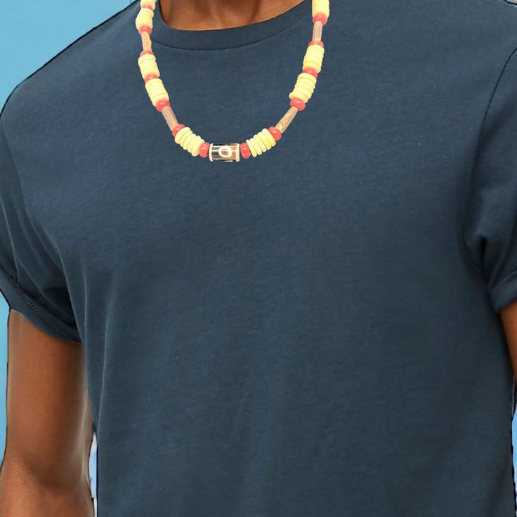 This necklace is handcrafted and looks stunning on any skin tone. It features a combination of yellow and red beads, accentuated with tribal-style glass beads, all brought together in the center. The vibrant colors of this necklace will definitely make heads turn and add a touch of class, flavor, and warmth to any outfit. It's a unique and eye-catching choker that will transform your look and leave a lasting impression. The necklace is 17 inches long and has a secure magnetic closure. Casual Yellow Beaded Necklaces With Round Beads, Traditional Colorful Beads Necklace For Summer, Casual Yellow Round Bead Necklaces, Yellow Necklaces With Colorful Beads For Summer, Casual Yellow Jewelry With Colorful Beads, Casual Large Beads Necklace For Festival, Bohemian Yellow Single Strand Beaded Necklace, Yellow Bohemian Single Strand Beaded Necklace, Casual Yellow Beaded Chain Jewelry