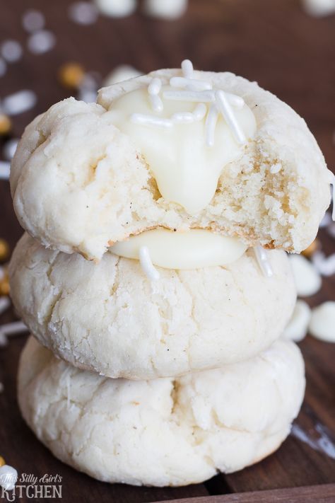 three cookies with icing and sprinkles stacked on top of each other