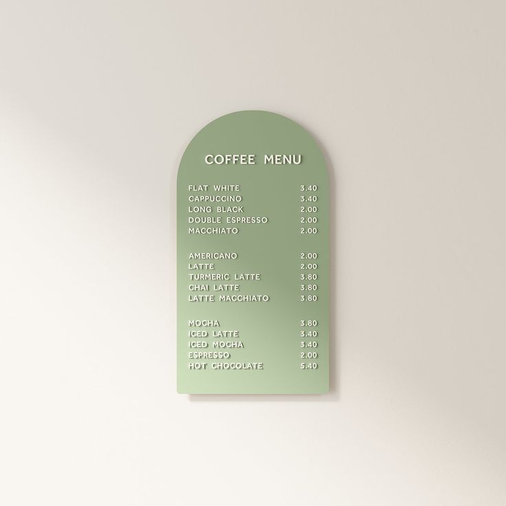 there is a green menu on the wall next to a coffee cup and saucer