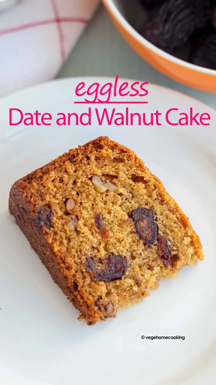 an eggless date and walnut cake on a white plate with a bowl of raisins in the background