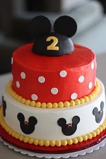 two tiered cake with mickey mouse on top