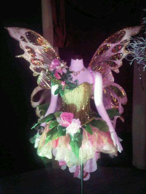 a dress made to look like a fairy with wings and flowers on it's chest