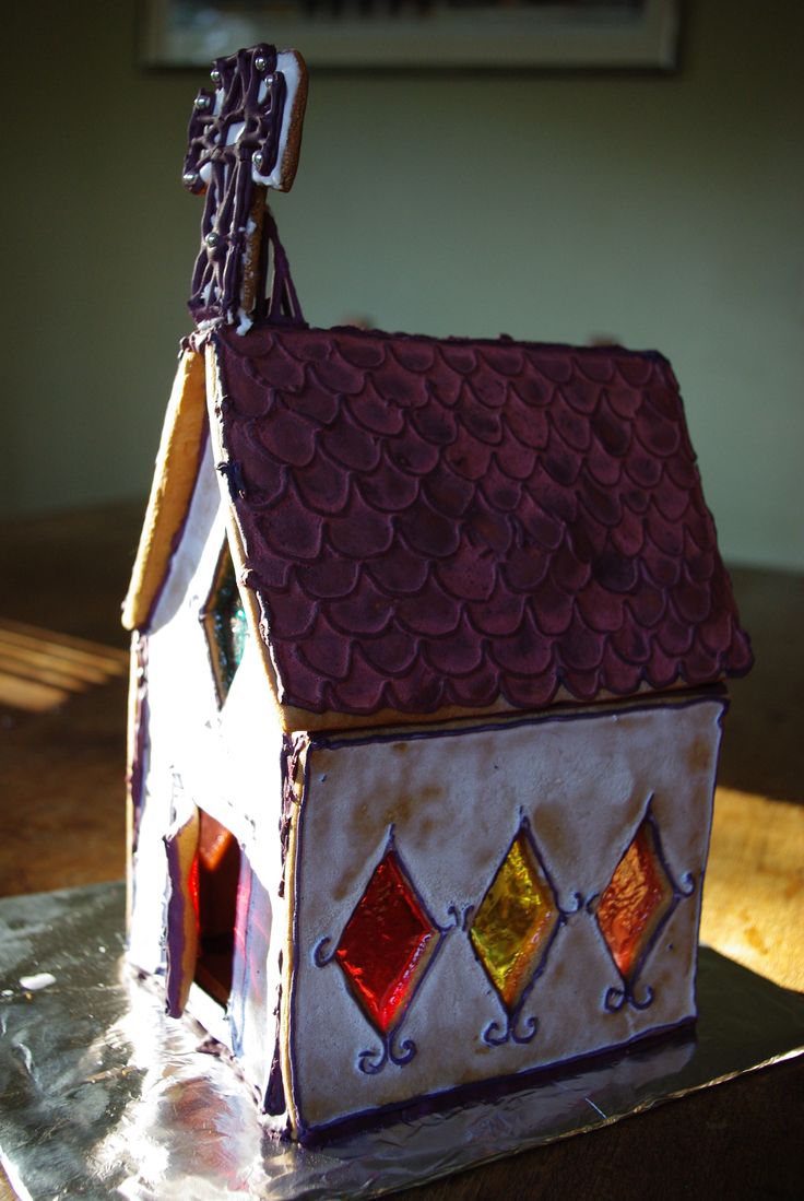 a house shaped cake sitting on top of a table