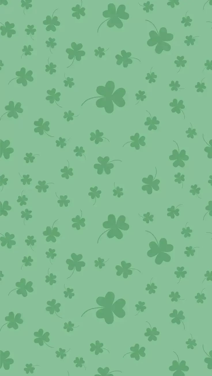 a green background with four leaf clovers