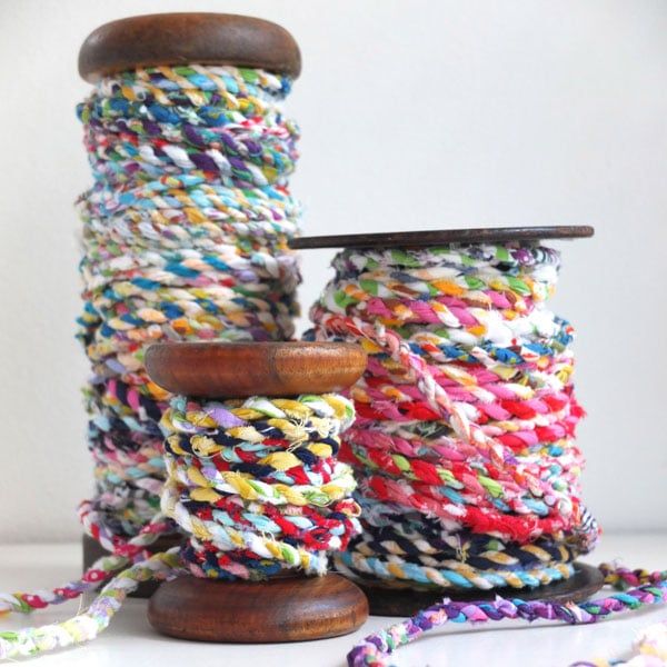 two spools of yarn sitting on top of each other with the words scrapbusting let's make fabric twine