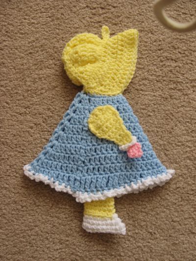 a crocheted stuffed animal wearing a dress