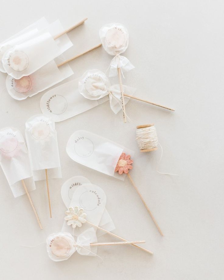 several lollipops are arranged on top of each other with some knitting needles