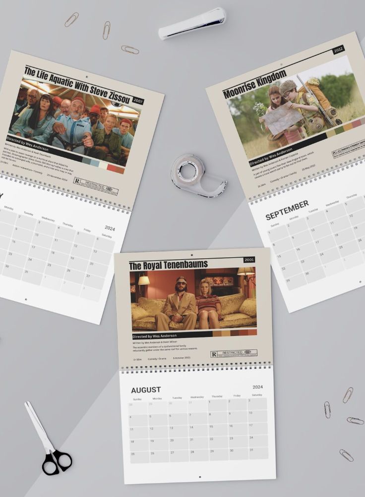 three calendars with images of people on them next to scissors and other items that have been placed around them