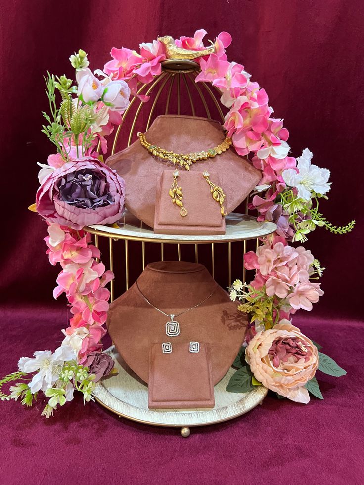 three tiered display with jewelry and flowers