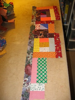 the table is covered with many different pieces of fabric