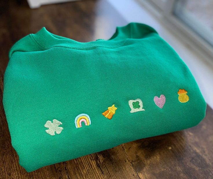 The perfect design for St. Patrick's Day or just a cute sweatshirt for any day!! :) These sweatshirts are super soft and cozy!  Choose a color and a size for yours. (Pictured is a green crewneck)  Note: sizing is unisex adult. All of my items are made with care and are machine washable! Green Long Sleeve Sweatshirt With Embroidered Graphics, Green Embroidered Long Sleeve Sweatshirt, Green Long Sleeve Sweatshirt With Custom Embroidery, Casual Green Sweater With Embroidered Graphics, Green Cotton Sweater With Embroidered Graphics, Casual Green Sweatshirt With Embroidered Graphics, Green Embroidered Crew Neck Sweater, Cute Green Cotton Sweater, Cute Green Embroidered Tops