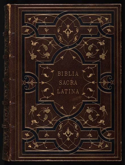 the front cover of a book with ornate designs and writing in gold on brown leather