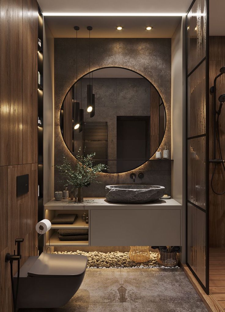 a bathroom with a large round mirror above the sink