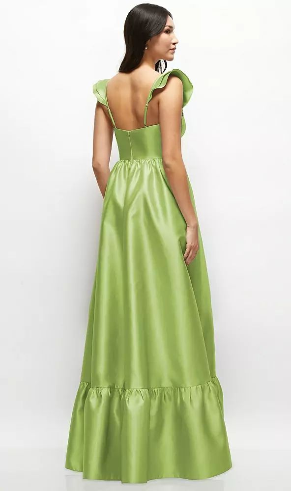 a woman in a long green dress with ruffles on the shoulders and back