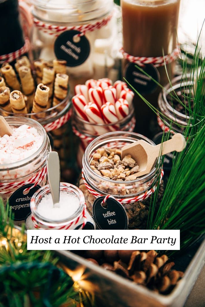 several jars filled with different types of candy canes and candies on top of a table