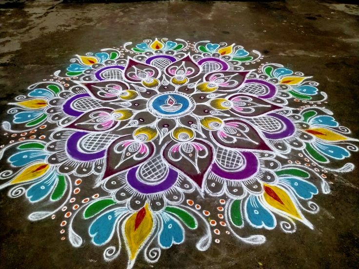 a colorful flower design is painted on the ground