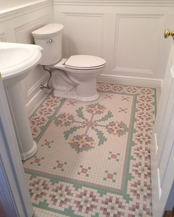 a white toilet sitting in a bathroom next to a sink