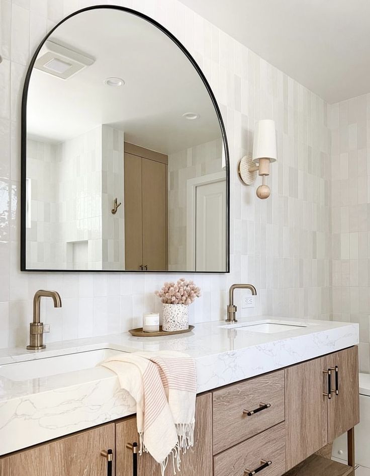 a bathroom sink with a large mirror above it