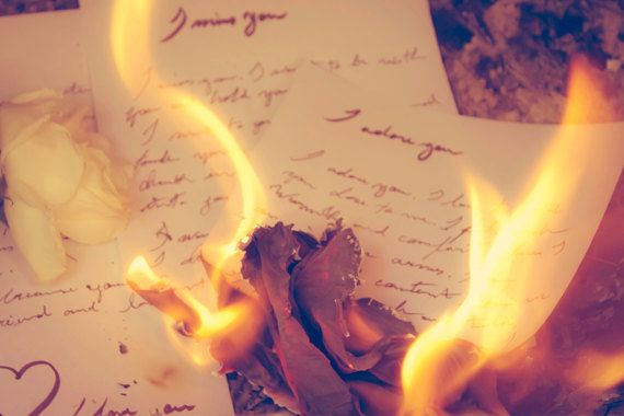 a burning piece of paper with writing on it