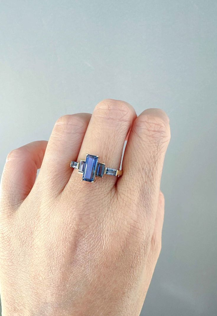 ♥ 2.3ctw Blue Purple Bi-Color Sapphire Engagement Ring 14K Gold ♥ Ring size: US 7 (Free resizing up or down 2 sizes) ♥ Material: 14K Gold ♥ Gemstone: Earth-mined center sapphire (1.45ct) and side sapphires (0.85ctw) Amethyst And Blue Sapphire Ring, Purple Blue Sapphire Engagement Ring, Blue Sapphire Ring With Baguette Cut Center Stone, Blue Sapphire Ring With Baguette Cut, Gia Certified Blue Baguette Cut Sapphire Ring, Gia Certified Blue Baguette Cut Ring, Blue Sapphire Baguette Cut Ring With Center Stone, Art Deco Blue Sapphire Rings, Art Deco Blue Gemstone Rings