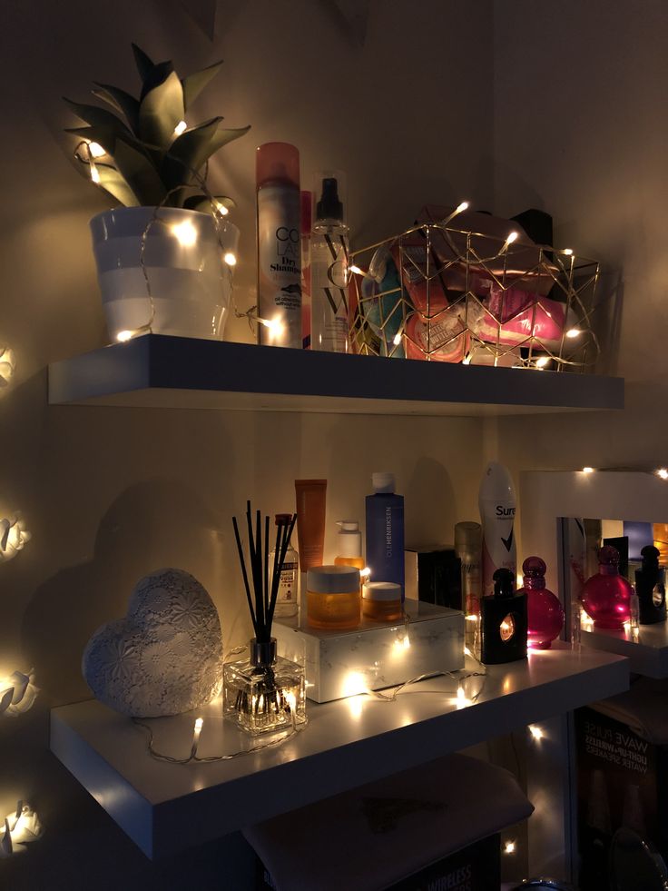 some shelves with candles and bottles on them