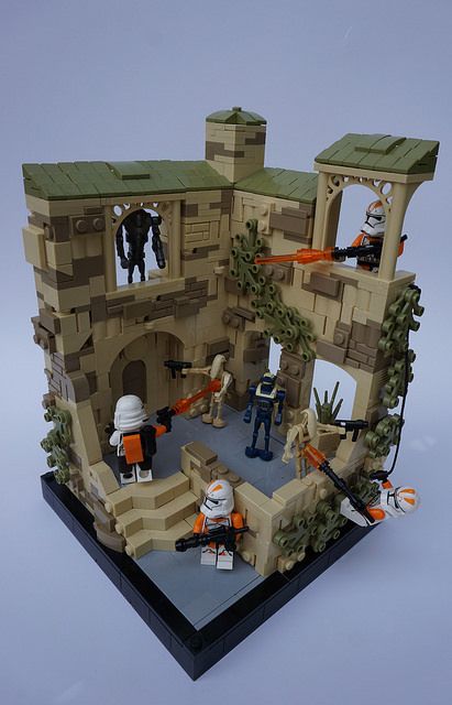 a lego model of a castle with figures on it