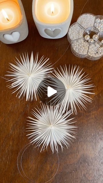 three candles sitting on top of a wooden table