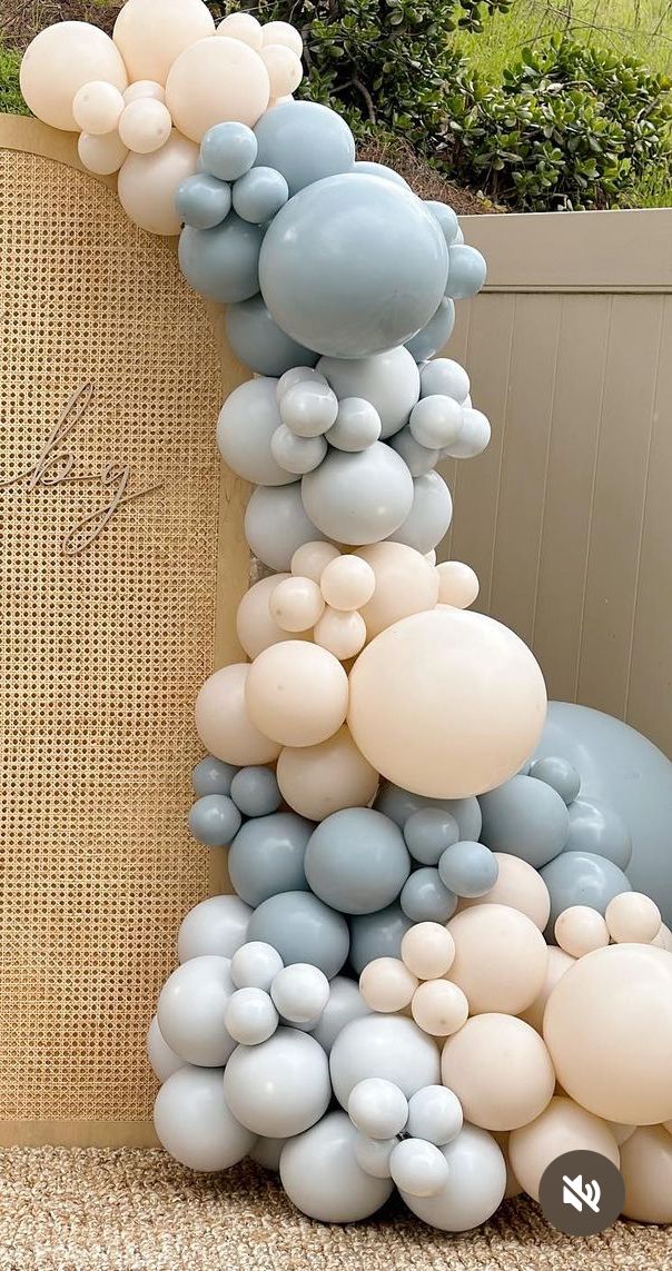 balloons are stacked on top of each other in the shape of a tower with clouds