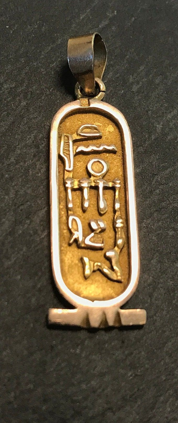 "A vintage Egyptian (Cario I believe-gold hallmark imaged) cartouche yellow gold beautifully detailed, necklace or bracelet pendant or charm.  Condition great, wt. 3 grams-test for 14k or better, size with gold bale is 1 1/2\".  IT is vintage." Antique Engraved Jewelry For Blessing Occasions, Antique Gold Jewelry For Blessing, Gold Etched Rectangular Pendant Jewelry, Antique Gold Jewelry For Blessing Occasions, Gold Rectangular Pendant With Etched Details, Antique Gold Necklace With Rectangular Pendant, Ornate Gold Rectangular Jewelry, Ornate Rectangular Gold Jewelry, Gold Engraved Jewelry For Blessing