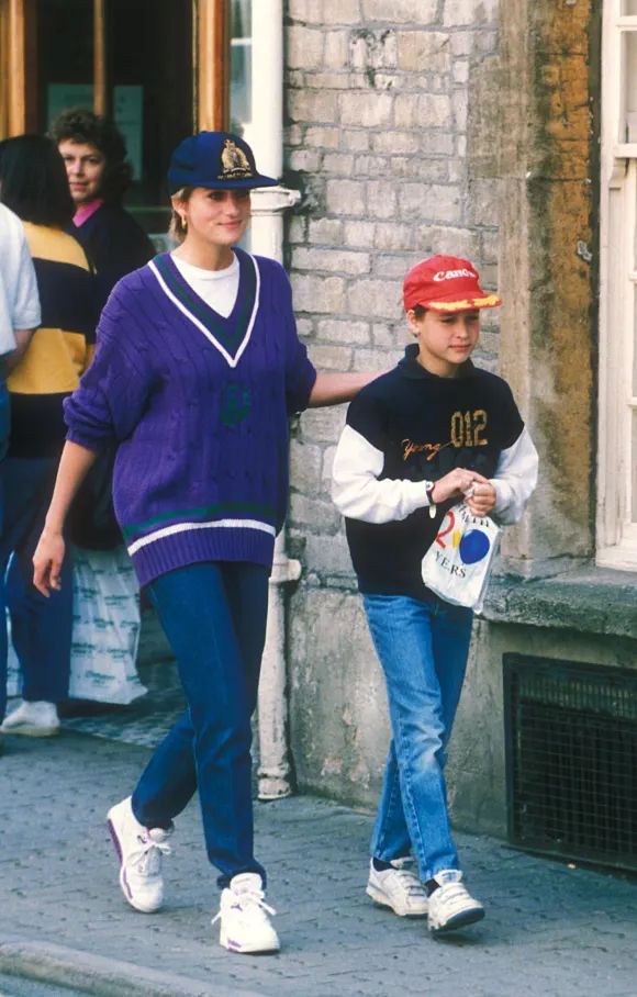 two women walking down the street in front of a building