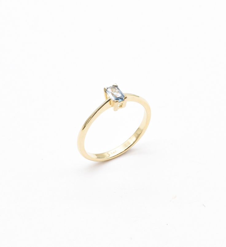 Blue Baguette Gold Ring set with Natural Blue Topaz, size 5x3 millimeters, 0.2 Carats.Solid 14k Yellow Gold ☞ made to last.Click here for ☞ Solid Gold CollectionBlue Topaz Details:• Natural Blue Topaz • Weight: 0.2 Carats• Dimensions: 5x3mm• Color: Blue• Cut: Baguette• Origin: BrazilSolid Yellow Gold Details:• 14k Solid Yellow Gold• Dimensions: Band width ≈ 1.6mm, thickness ≈ 1mm• Lasts a lifetime - Perfect for everyday use (won’t tarnish)! *Final weight & dimensions depending on the chosen ring 14k Gold Baguette Cut Topaz Ring, Blue 14k Gold Ring With Baguette Cut, Minimalist Yellow Gold Blue Topaz Ring, Gold Baguette-cut Topaz Ring As A Gift, Blue 14k Gold Baguette-cut Jewelry, Gold Ring Sets, The Chosen, 14k Gold Ring, Gold Collection