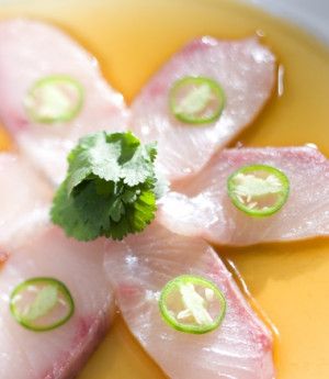 some kind of food that is on top of a yellow plate with green garnish