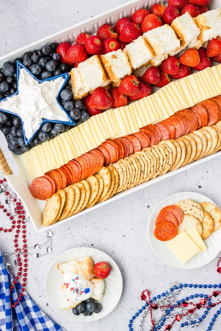 an american flag platter with crackers, fruit, and cheeses on it