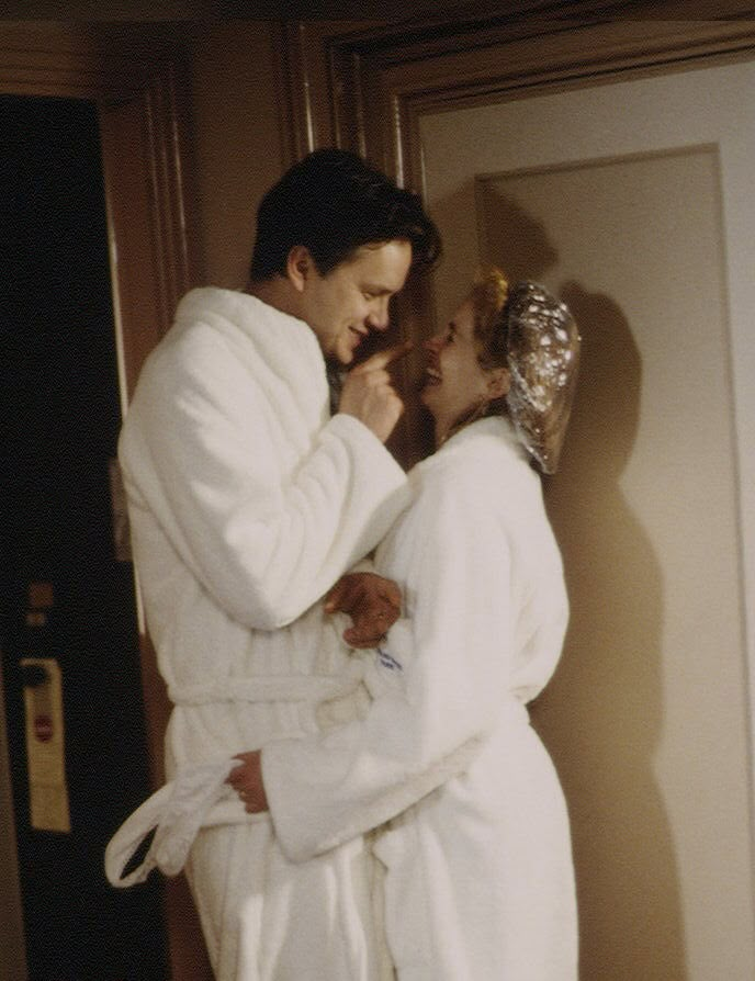 a man and woman in robes standing next to each other