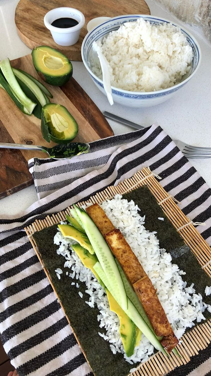 an image of some food on a plate with rice and avocado in the background