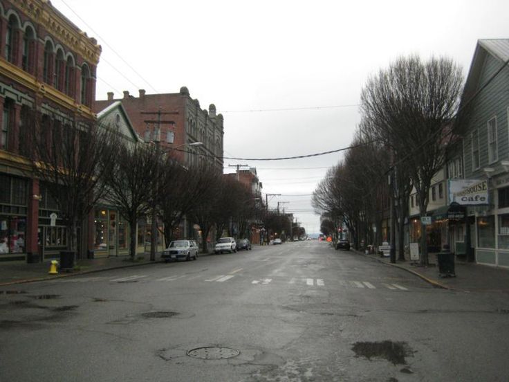 an empty street with cars parked on both sides