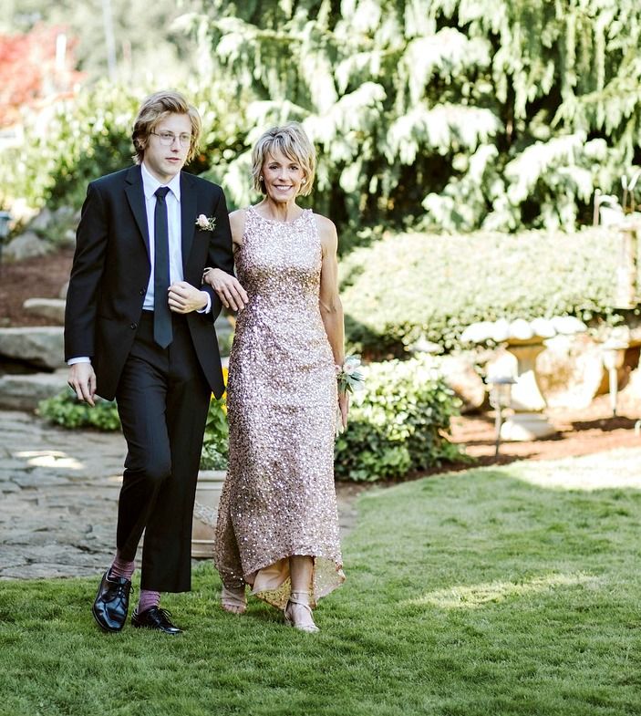 a man and woman walking in the grass